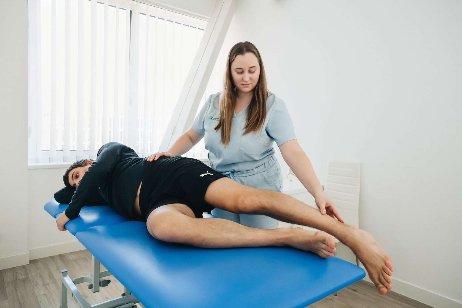 Physiotherapist assisting a patient during a treatment session